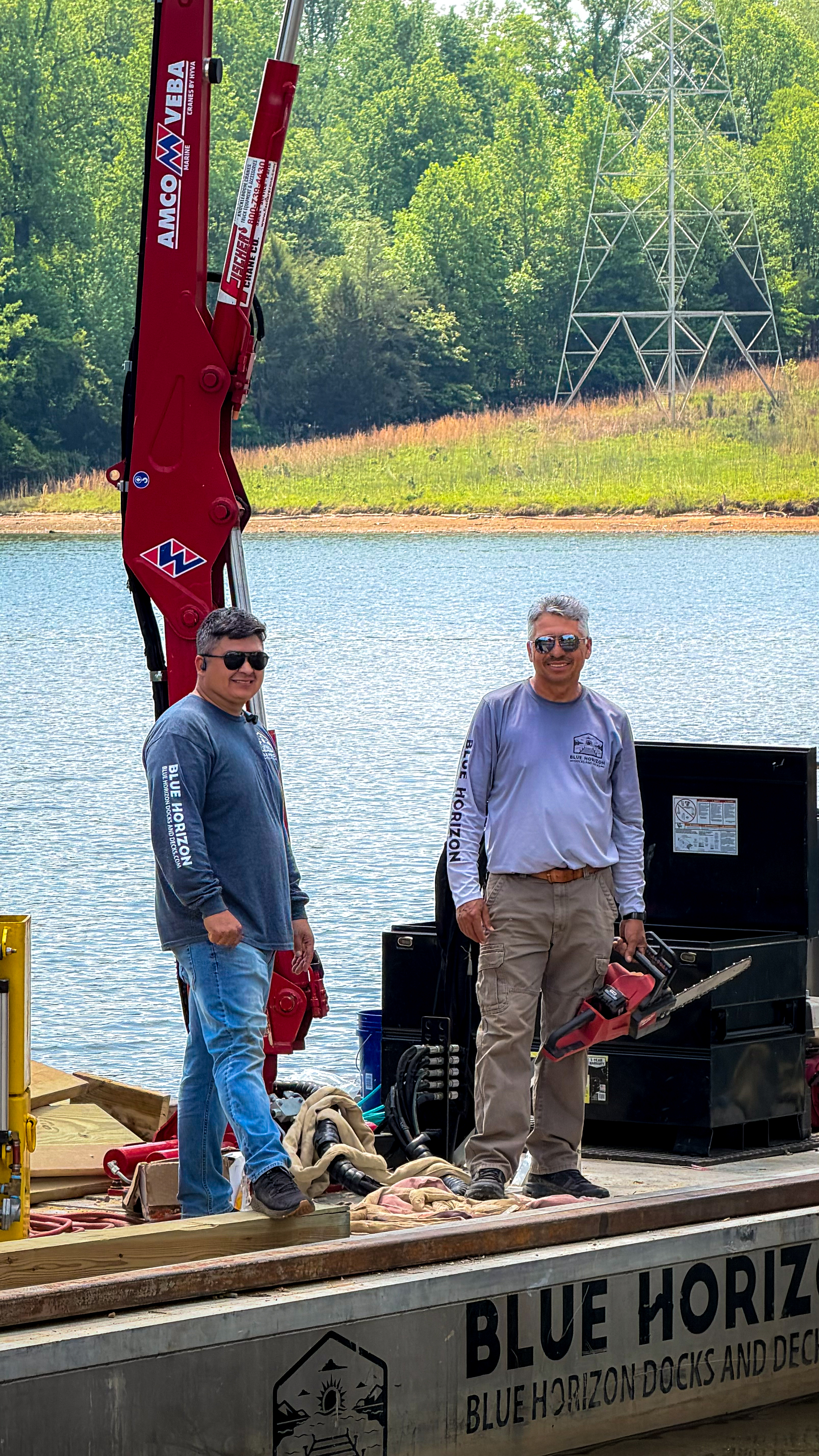 Christian and Sergio Rodriguez on the Blue Horizon work barge at a Tennessee lake