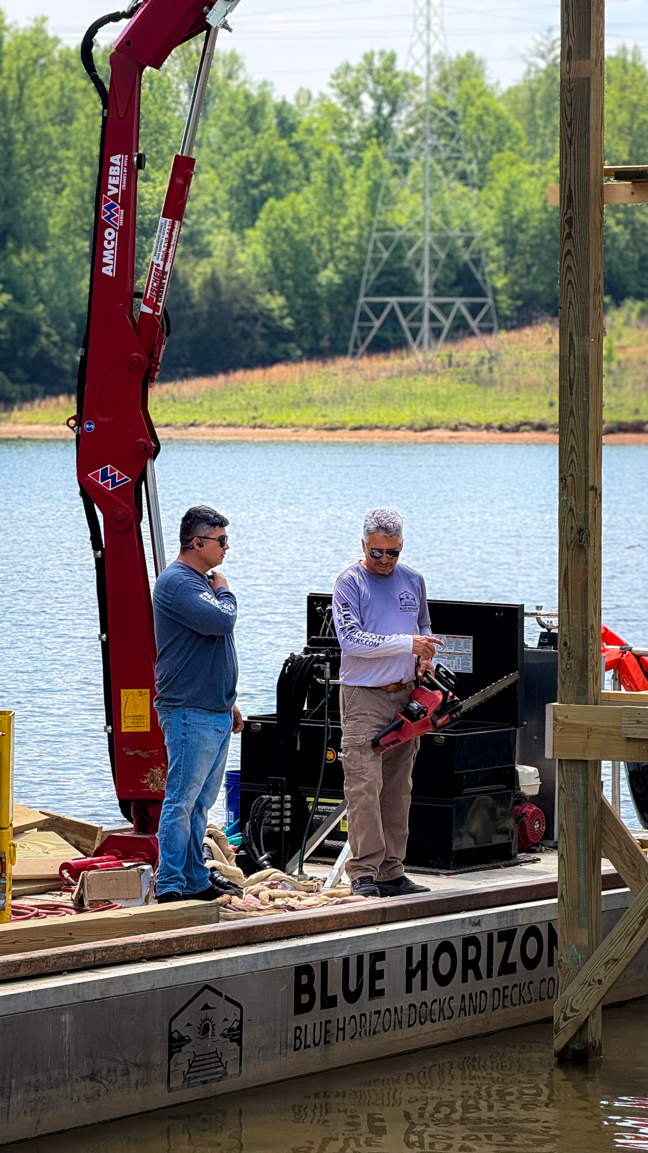 Crew on the Blue Horizon barge with rigging and dock-building equipment