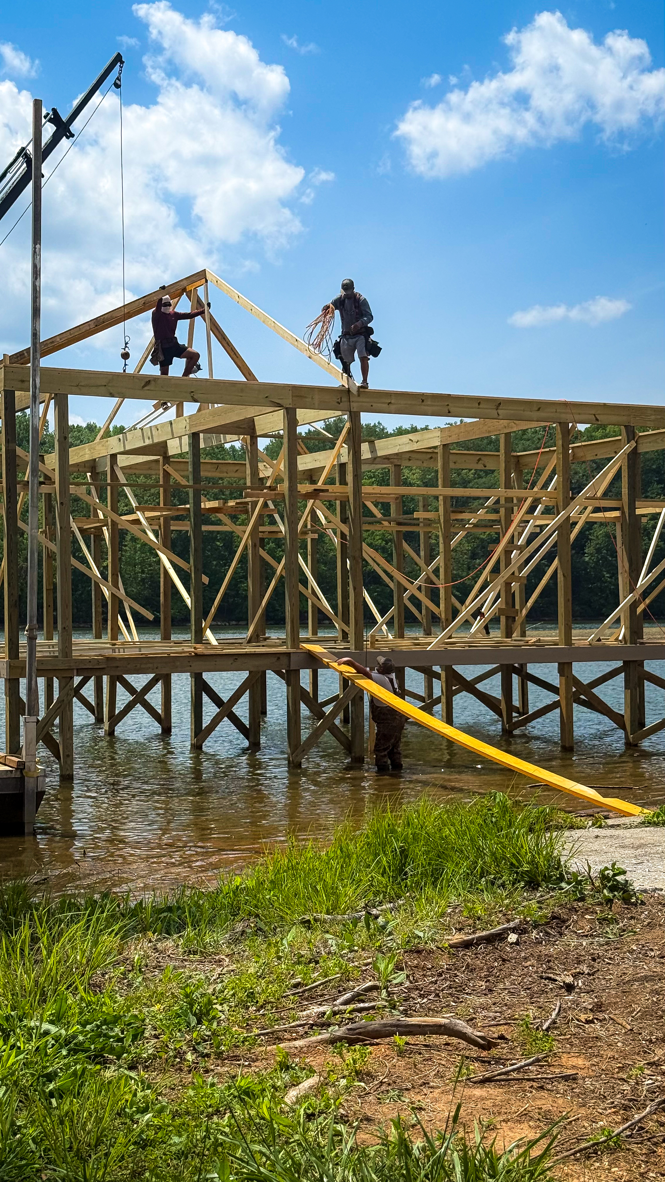Blue Horizon crew framing a dock structure over the water