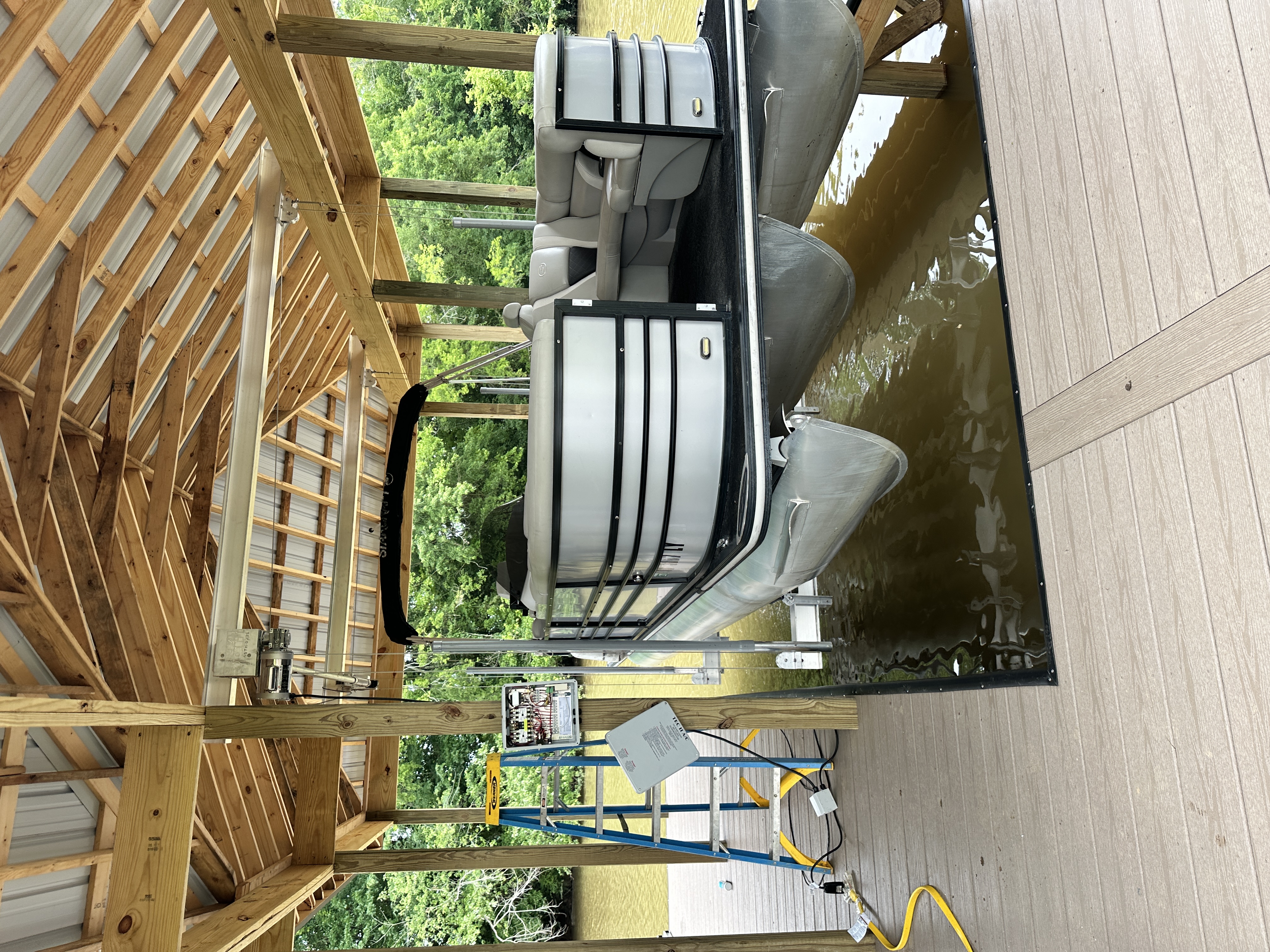 Covered slip with pontoon on boat lift, built by Blue Horizon Docks and Decks on a Tennessee lake